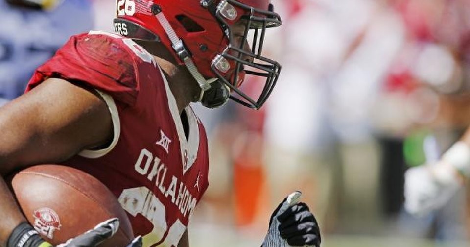 OU football Kennedy Brooks keeps a tight grip on the football