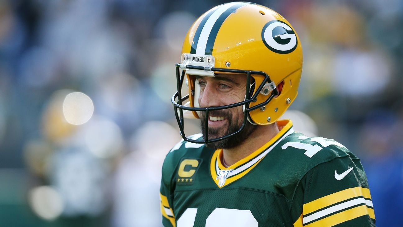 Aaron Rodgers throws 5 TDs, runs for another in win