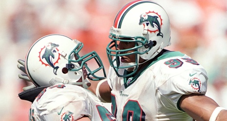 Miami Dolphins' Jason Taylor (99) tries to get to Tampa Bay