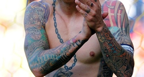 Can you identify the footballer from their tattoo?