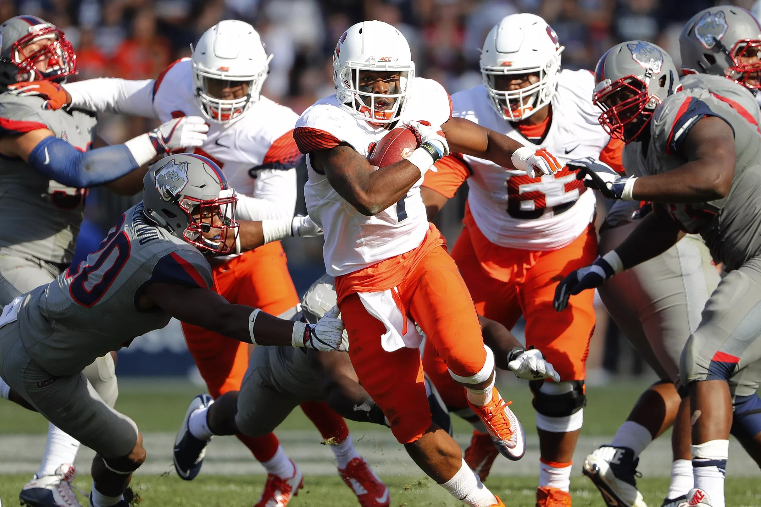 Syracuse wearing white helmets, white jerseys, orange pants vs. Louisville